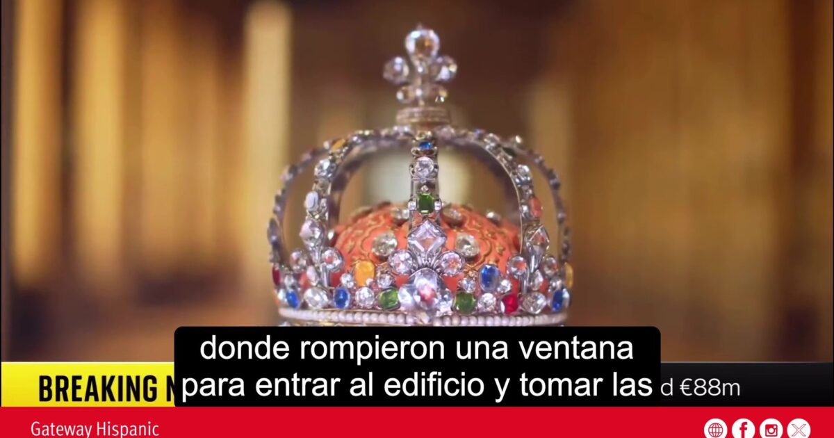 Close-up of an ornate crown featuring colorful gemstones, highlighting its intricate design and craftsmanship against a blurred background.