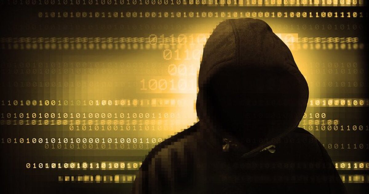 Silhouetted figure in a hoodie against a backdrop of binary code, symbolizing cybersecurity and digital anonymity.
