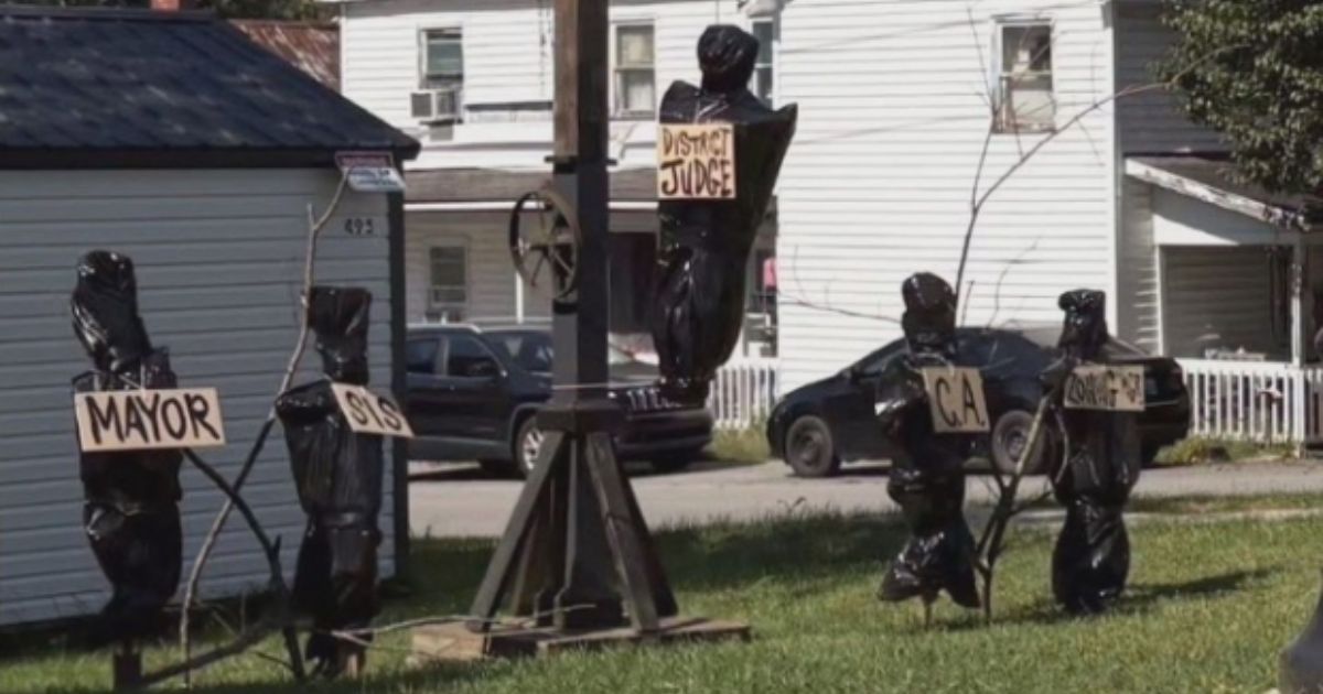 The display featured a gallows and several body bags with signs depicting the titles of local government officials.