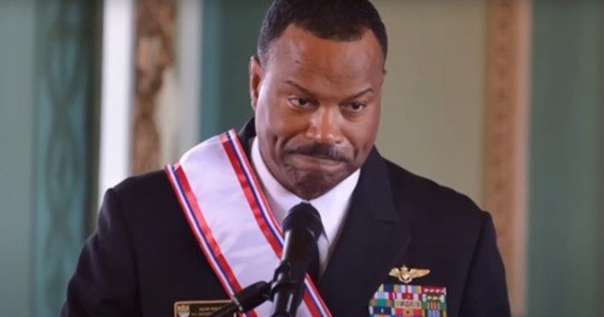 A naval officer in formal dress delivers a heartfelt speech, showcasing military honors and emotional expression during a significant ceremony.