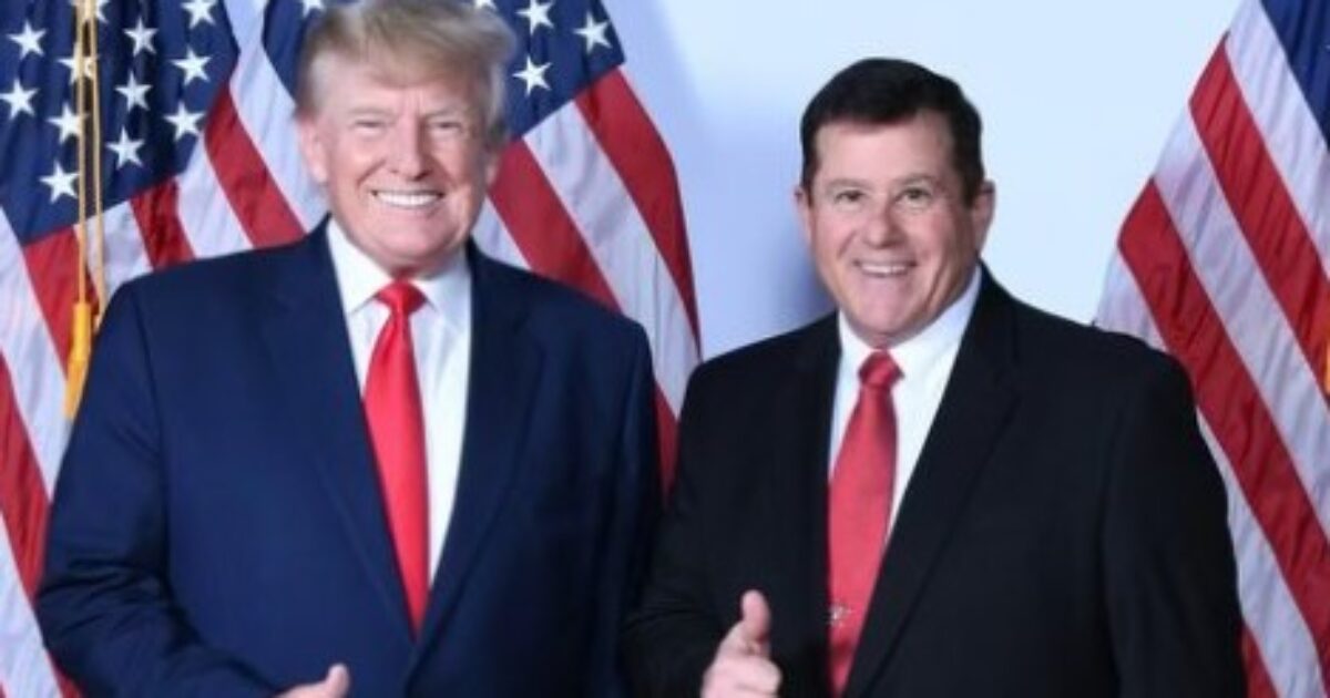 Donald Trump and a companion pose with thumbs up in front of multiple American flags, showcasing a moment of camaraderie and patriotism.