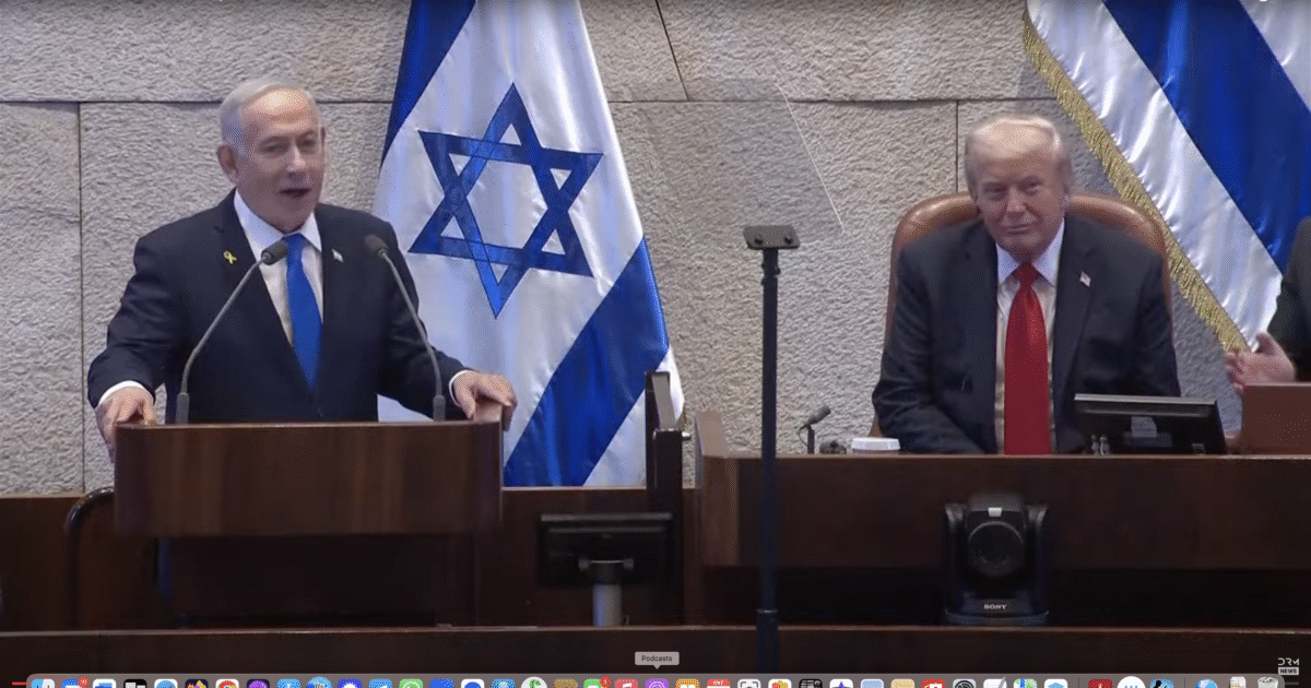 Israeli Prime Minister Netanyahu delivers a speech at the Knesset alongside former President Trump, with Israeli flags in the background.
