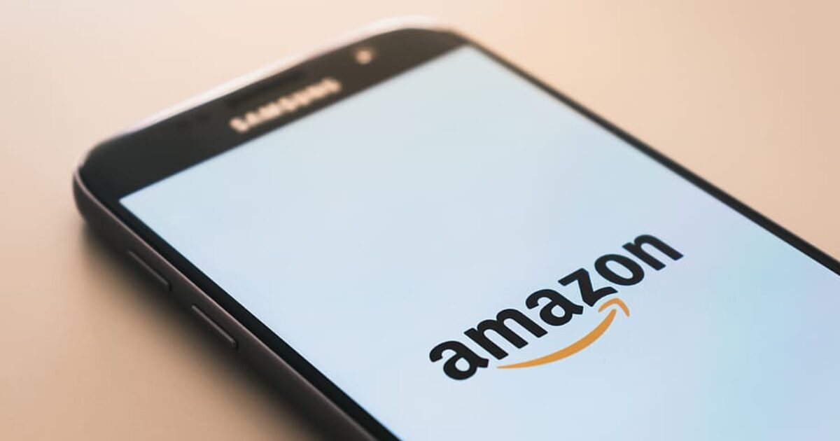 Samsung smartphone displaying the Amazon logo on its screen, highlighting the e-commerce platform's mobile accessibility.