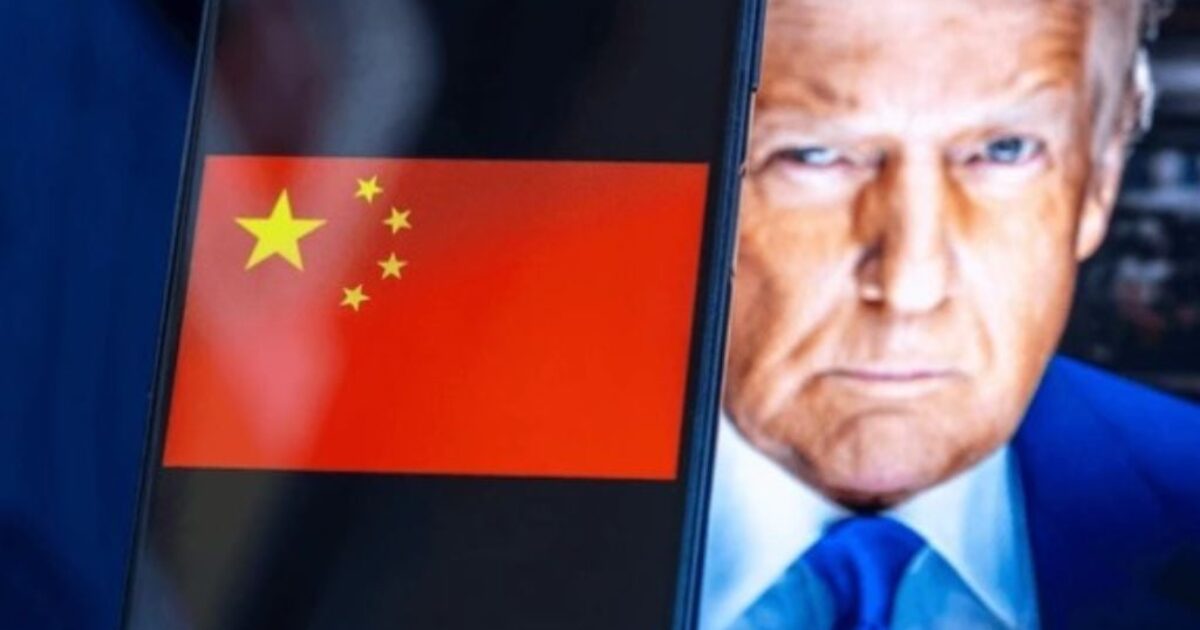 A smartphone displaying the Chinese flag alongside a close-up image of a man with blonde hair and a blue suit, symbolizing political themes.