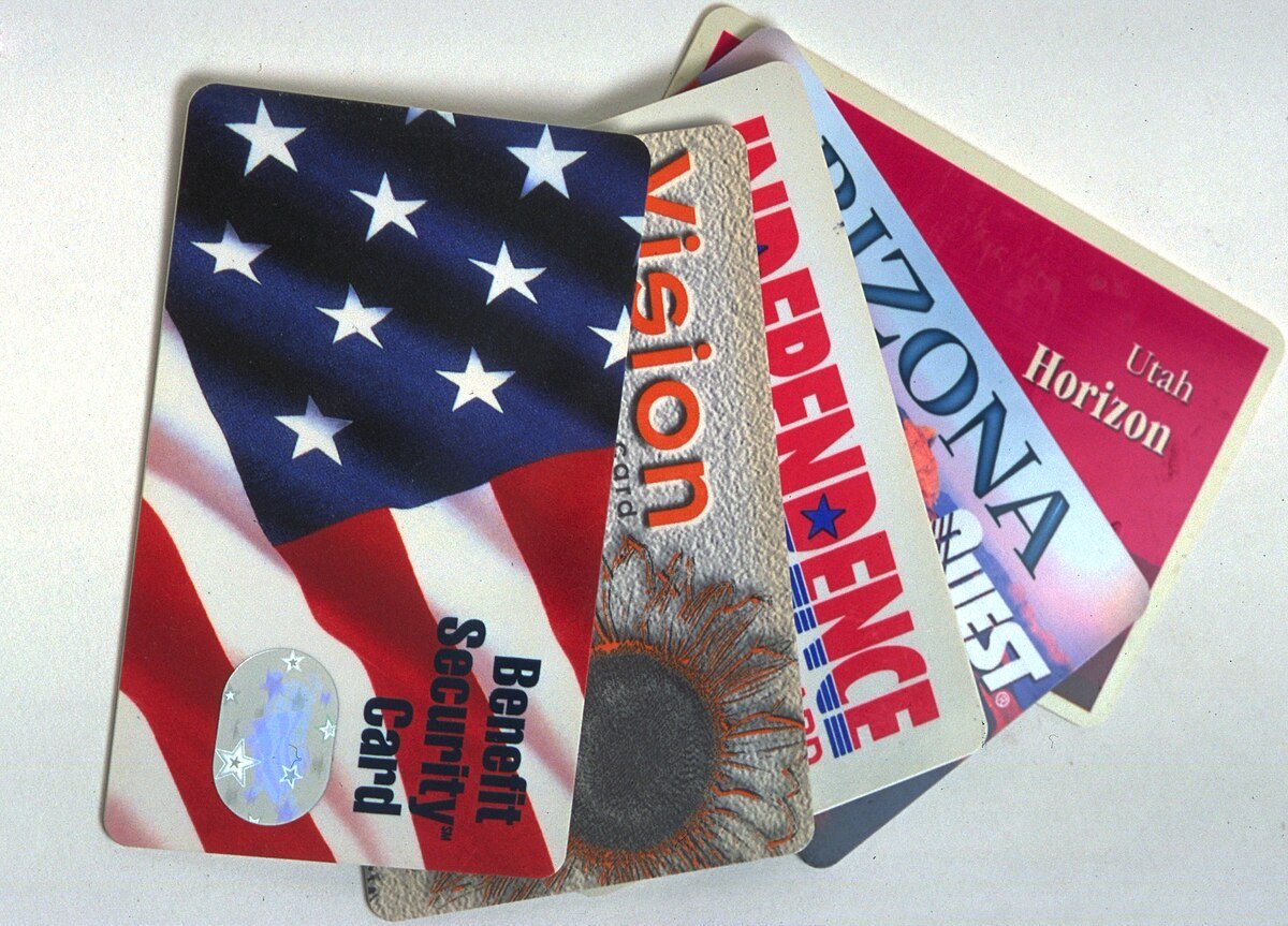 A collection of various benefit and identification cards featuring designs with the American flag and state-specific branding.