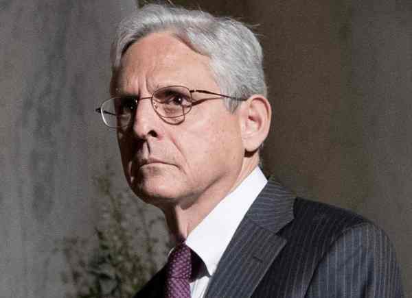 Merrick Garland, U.S. Attorney General, poses in a formal suit with a serious expression, highlighting his role in the justice system.