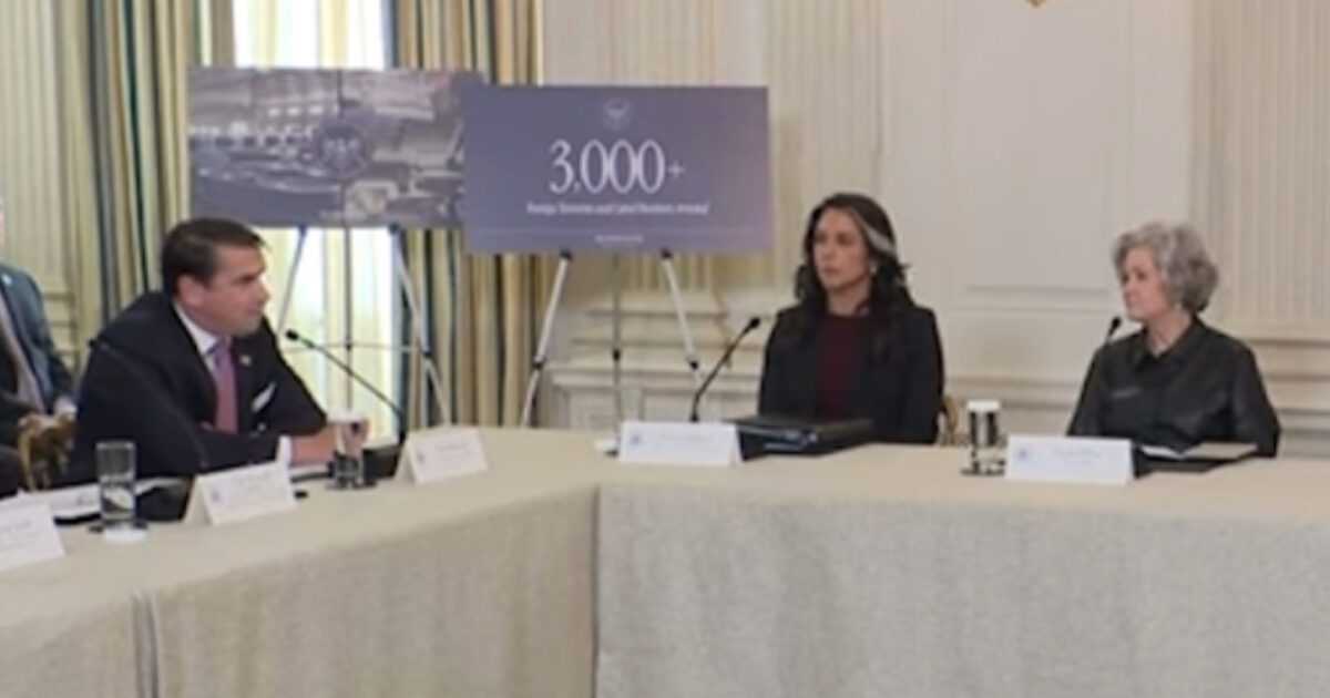 Meeting at the White House discussing foreign investment, featuring three officials and a presentation highlighting over 3,000 new jobs created.
