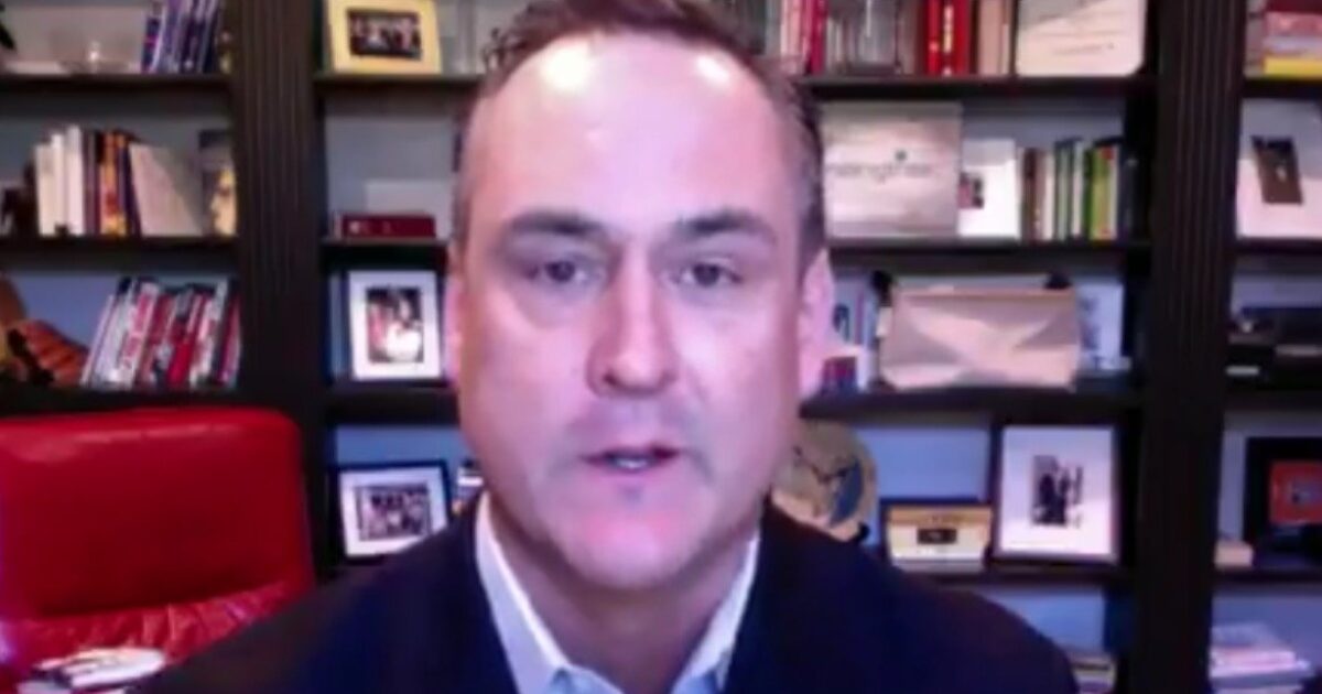 Professional man speaking from a home office, with bookshelves and framed photos in the background, highlighting a personal and engaging workspace.