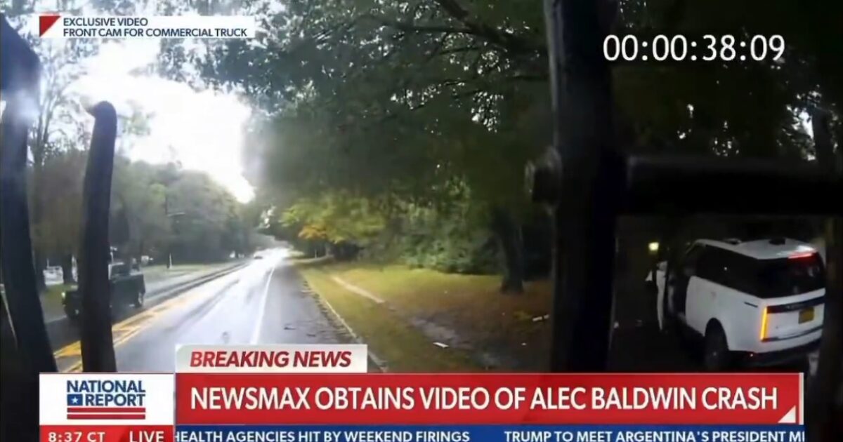 Dashcam footage from a commercial truck capturing a scene related to the Alec Baldwin crash on a rainy road surrounded by trees.