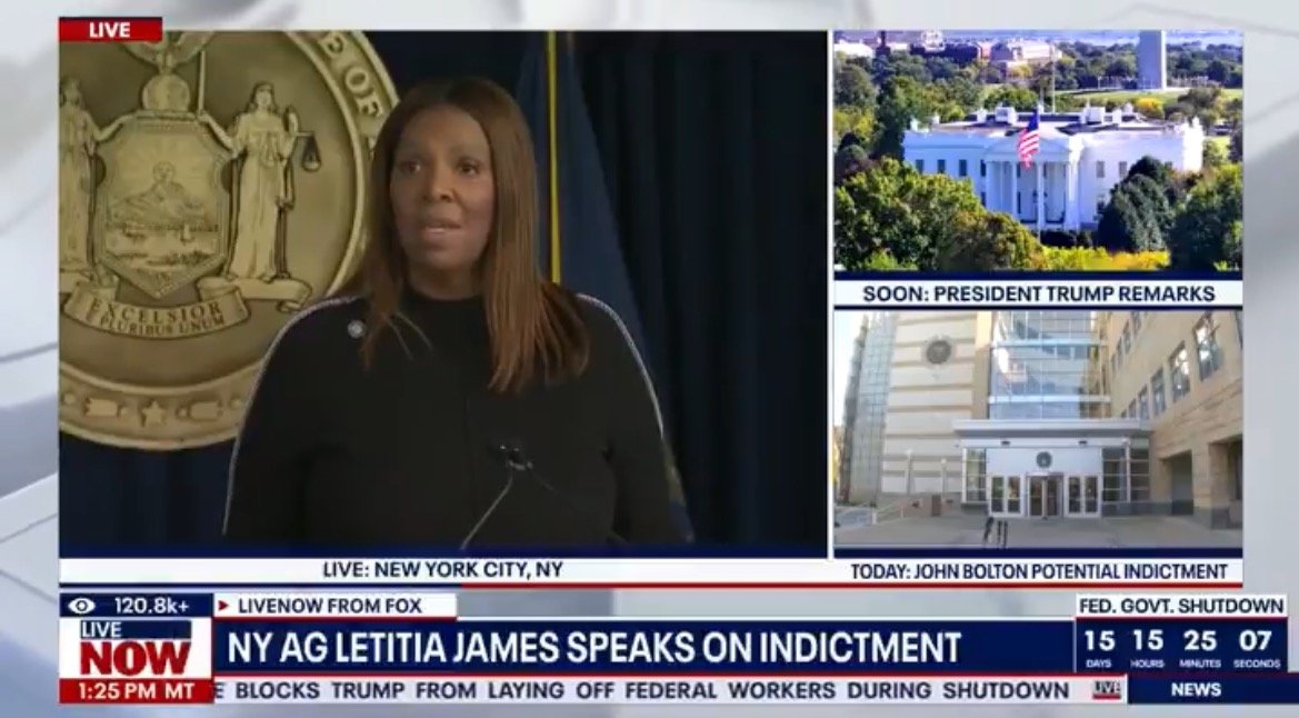 New York Attorney General Letitia James speaks at a press conference about an indictment, with the New York state seal in the background.