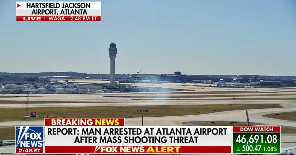 Hartsfield-Jackson Atlanta Airport with air traffic control tower, reporting a man arrested following a mass shooting threat.