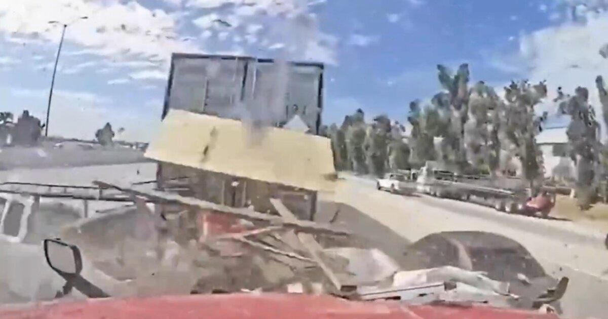 Dashcam footage capturing a close call with a truck carrying debris on a highway, showcasing the importance of road safety and awareness.