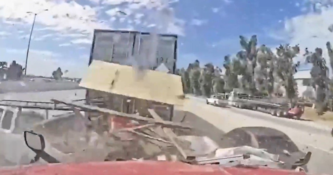 Dashcam footage capturing a close call with a truck carrying debris on a highway, showcasing the importance of road safety and awareness.