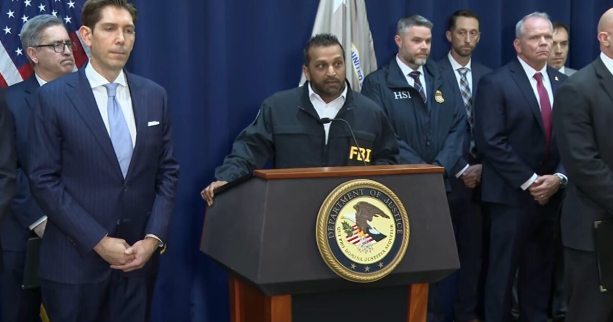 FBI officials hold a press conference with law enforcement representatives, discussing recent operations and updates on criminal investigations.