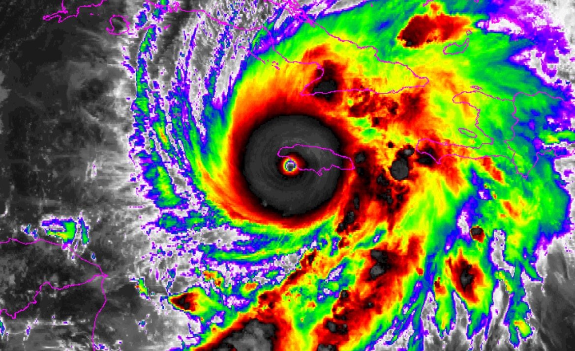 Satellite image of a powerful hurricane approaching Cuba, showcasing vivid colors and swirling clouds indicative of severe weather conditions.