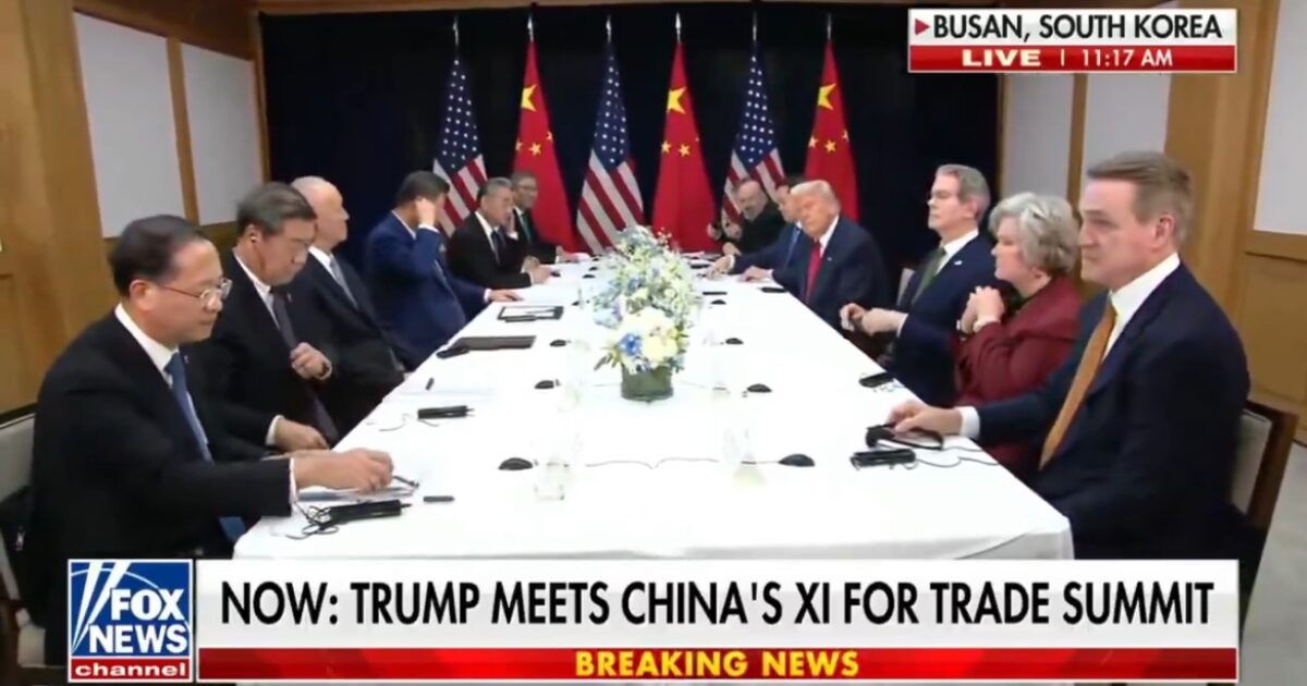 Trump and Xi Jinping engage in a trade summit meeting in Busan, South Korea, with officials from both nations present at the negotiating table.