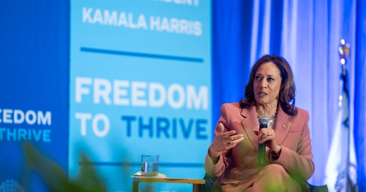 Vice President Kamala Harris speaking at the Freedom to Thrive event in Atlanta, discussing key issues while seated with a microphone.