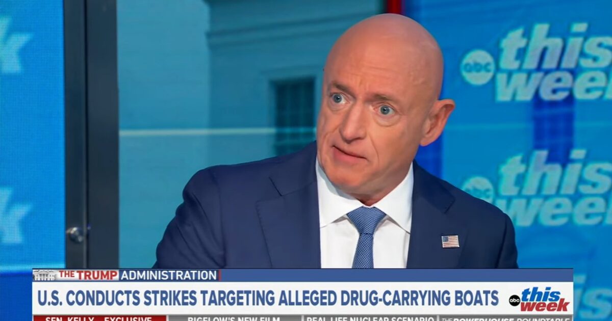 A man in a suit discusses U.S. military strikes against drug-carrying boats on a news program, highlighting current policy issues.