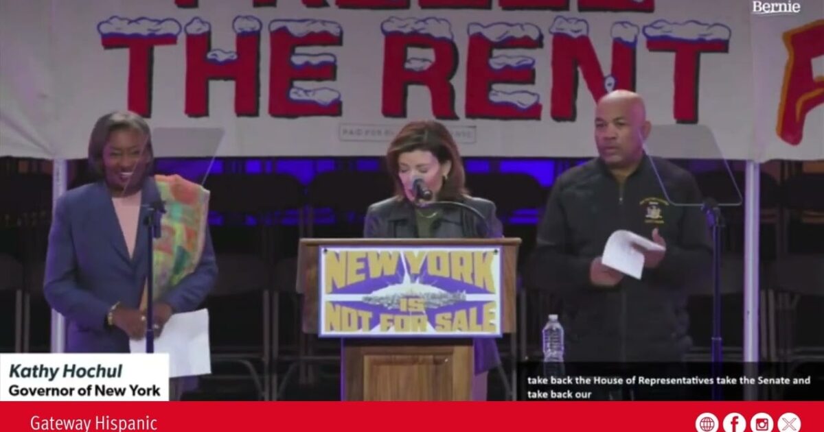 Kathy Hochul, Governor of New York, speaks at a rally advocating for housing rights, emphasizing the message "New York is not for sale" on stage.