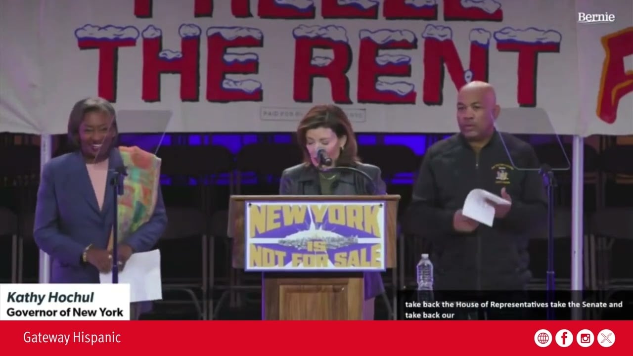 Kathy Hochul, Governor of New York, speaks at a rally advocating for housing rights, emphasizing the message "New York is not for sale" on stage.