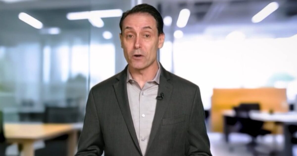 Business professional presenting in a modern office setting, discussing important topics related to corporate strategies and workplace dynamics.