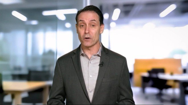 Business professional presenting in a modern office setting, discussing important topics related to corporate strategies and workplace dynamics.