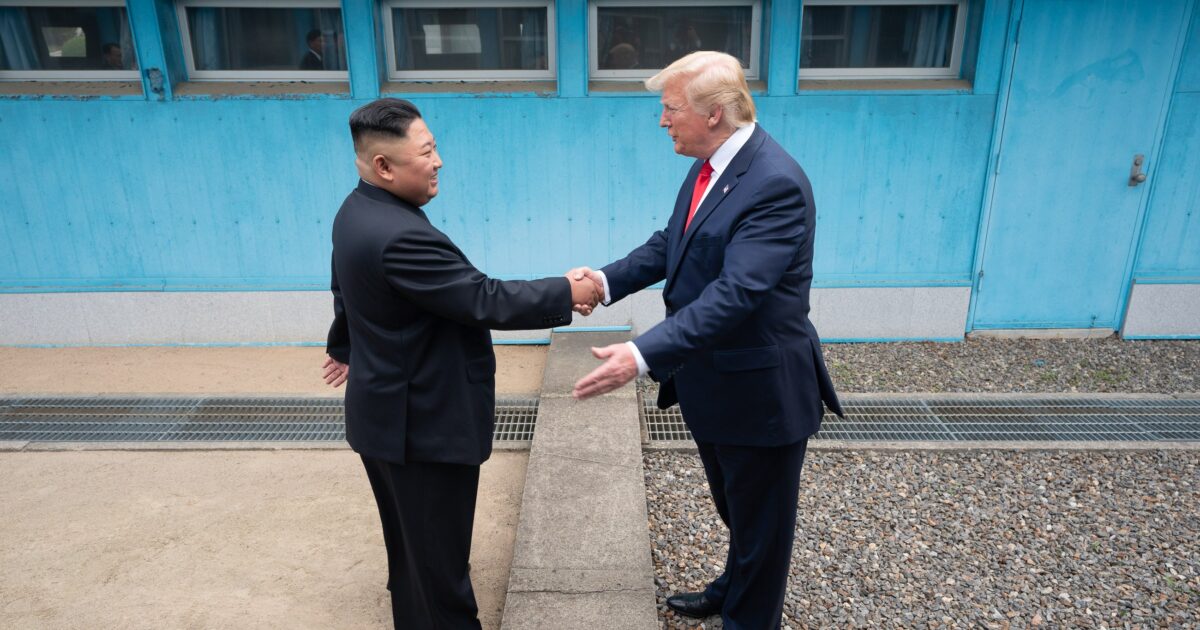 Kim Jong-un and Donald Trump shake hands during their historic meeting at the Korean Demilitarized Zone, symbolizing diplomatic efforts between North Korea and the United States.