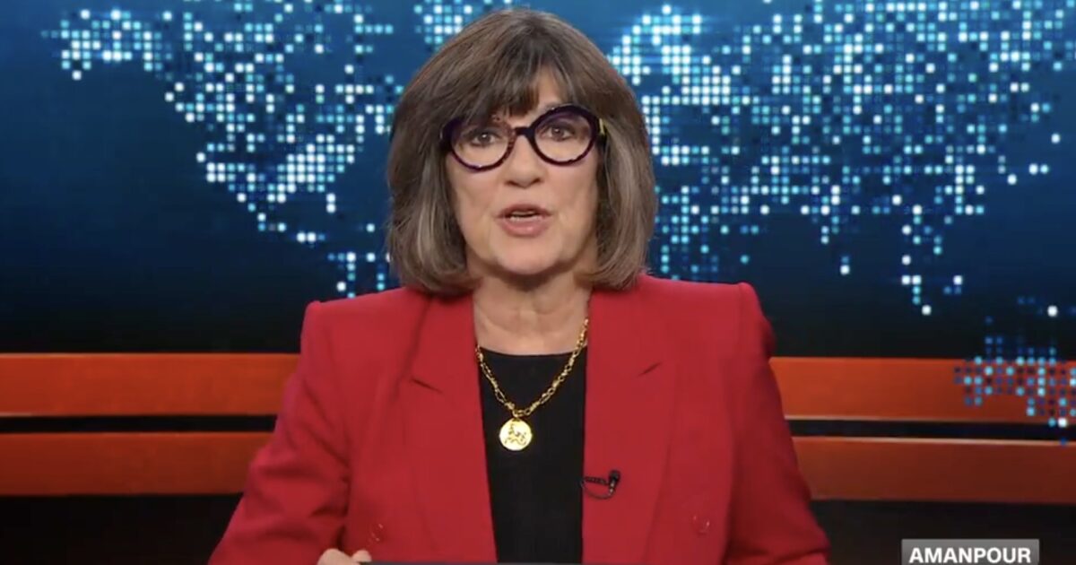 News anchor in a red blazer presents a segment against a digital world map background, highlighting current events and global issues.