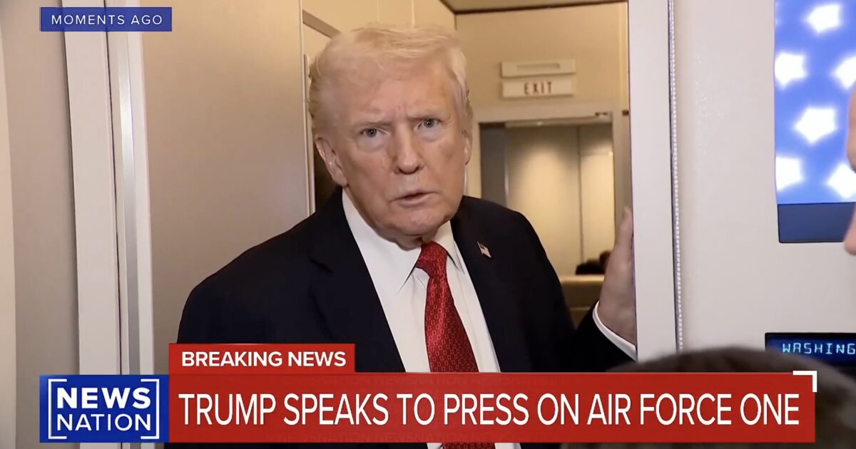 Donald Trump addressing the press on Air Force One, with a serious expression and a backdrop of the aircraft's interior.