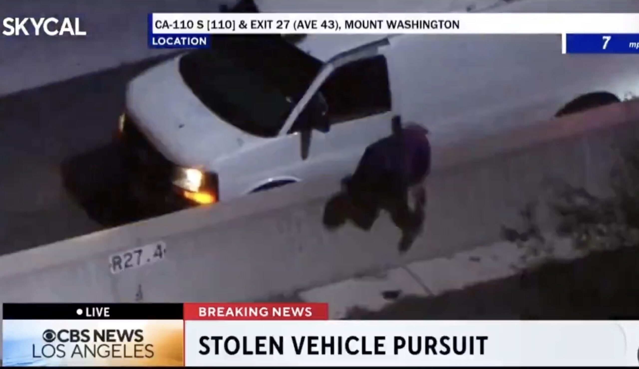 Police chase of a stolen white van on CA-110 South near Mount Washington, with a suspect attempting to escape as seen from above.