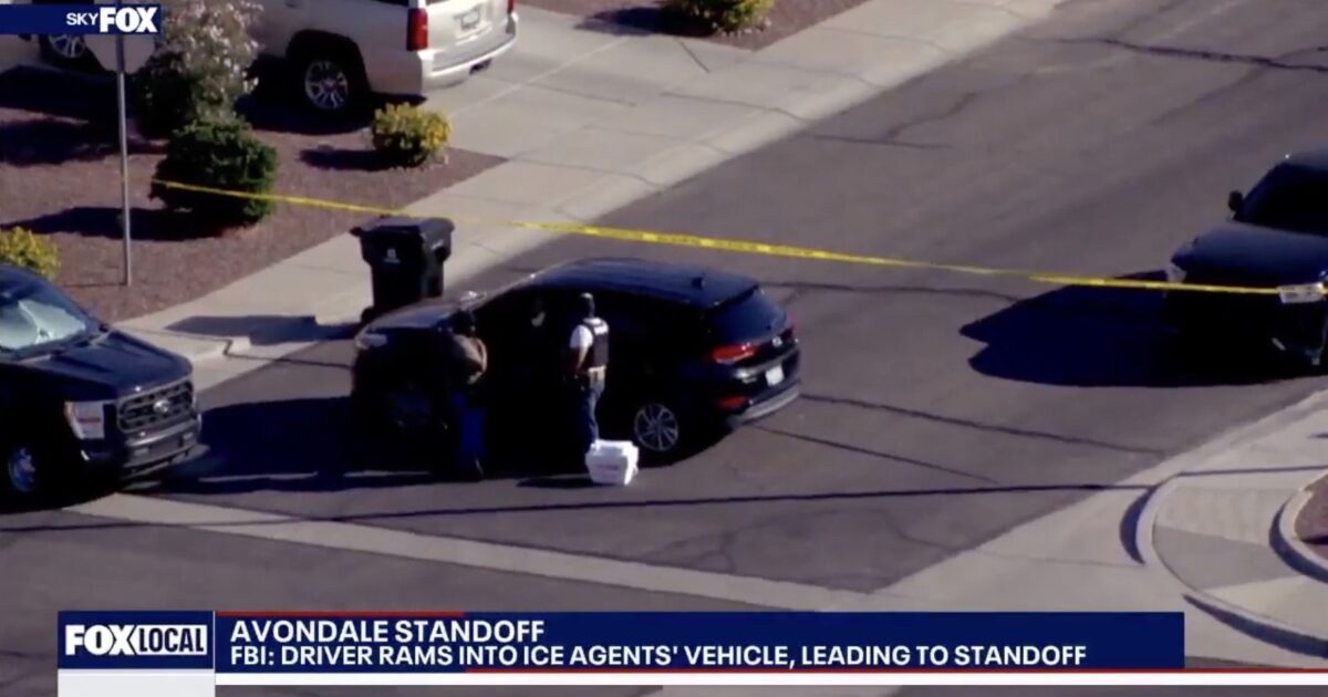 FBI standoff in Avondale after a driver collided with ICE agents' vehicle, with police investigating the scene marked by caution tape.
