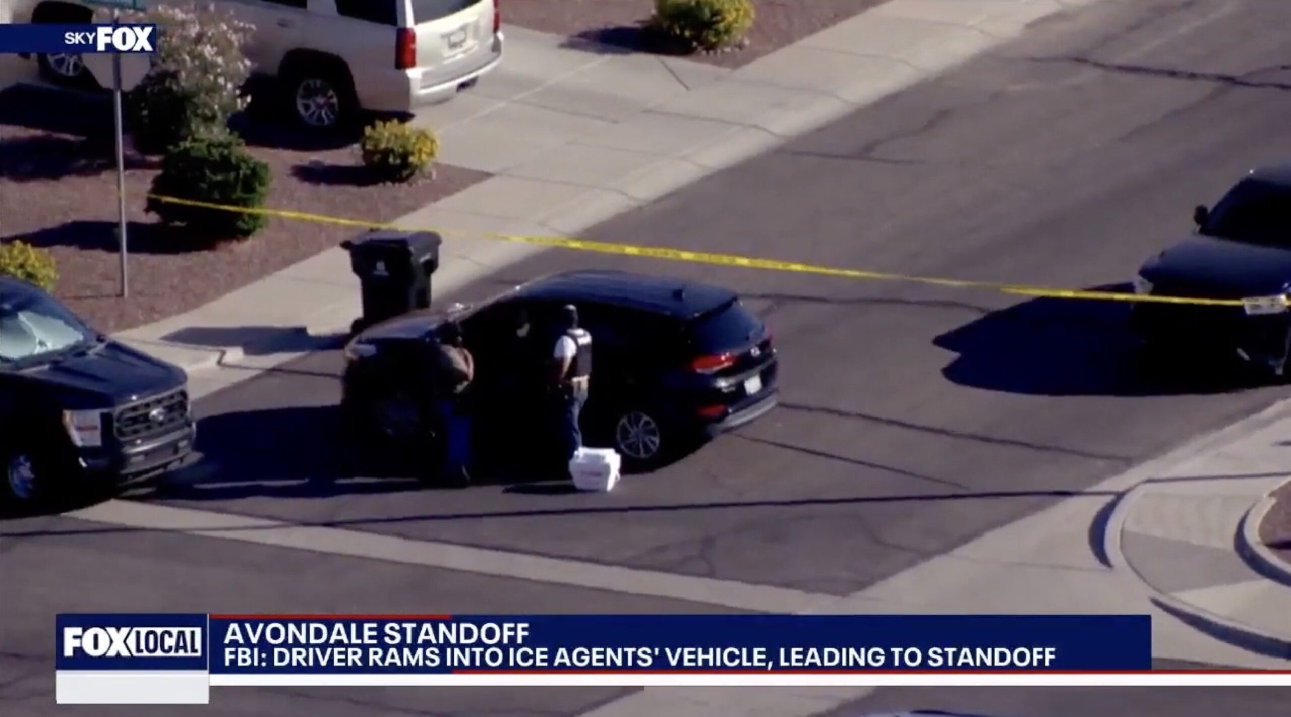 FBI standoff in Avondale after a driver collided with ICE agents' vehicle, with police investigating the scene marked by caution tape.