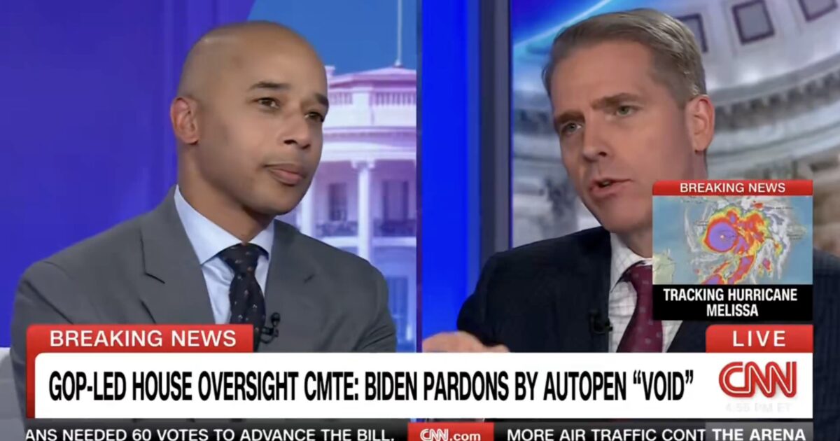 Two male commentators discuss breaking news on CNN regarding Biden's pardons and the ongoing tracking of Hurricane Melissa.
