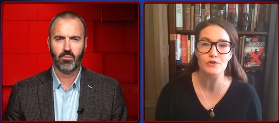 A man and a woman discuss historical topics on a video call, with bookshelves featuring historical texts in the background.