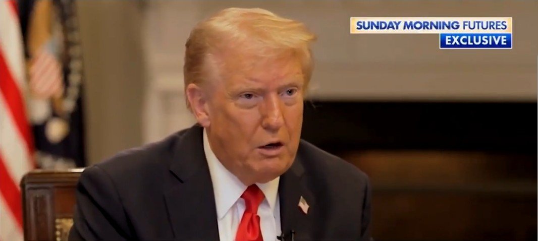 Donald Trump speaking during an exclusive interview on Sunday Morning Futures, with the Presidential seal and U.S. flag visible in the background.