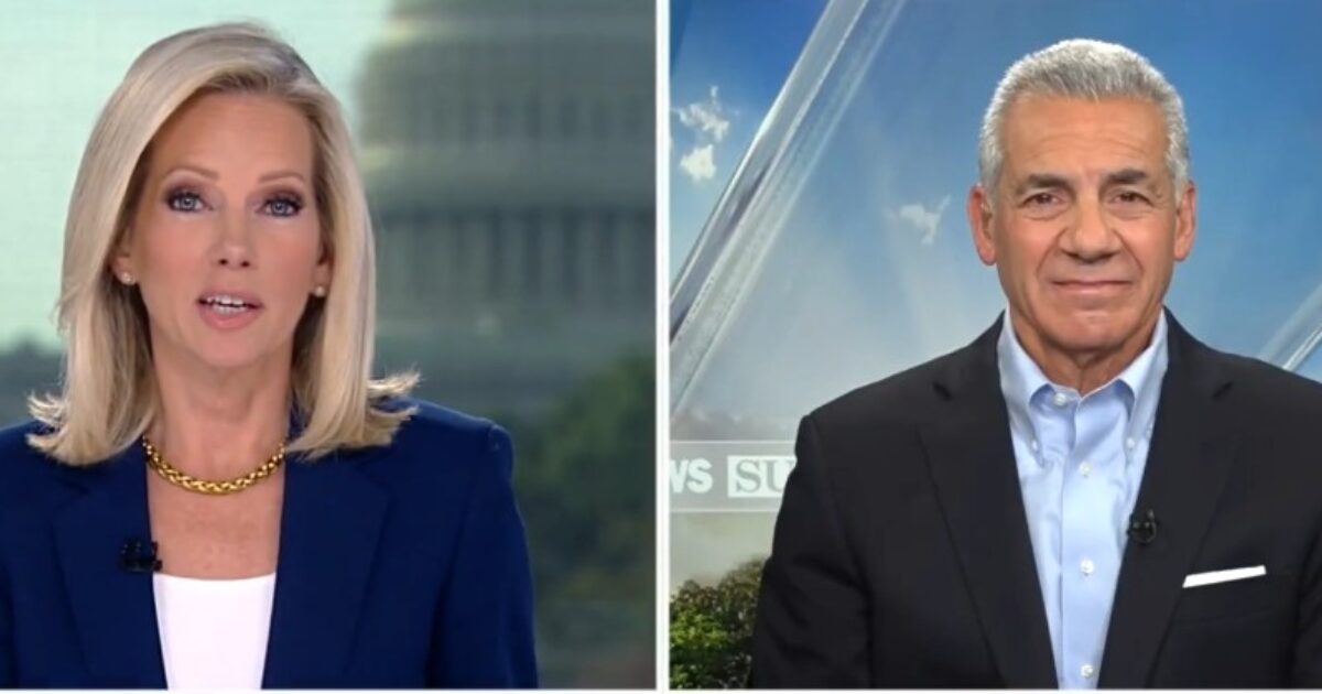 News anchors discussing current events with the U.S. Capitol in the background, showcasing a professional broadcast setting.