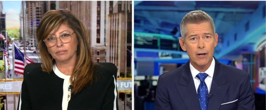 Two news anchors discussing current events, with a cityscape and American flags in the background, highlighting a financial news segment.