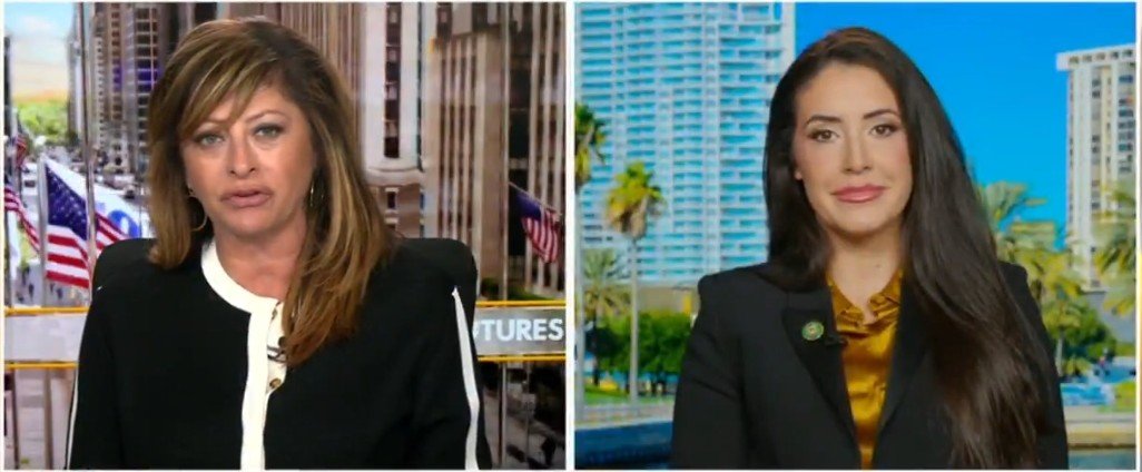 Two female hosts engaged in a discussion on a news segment, featuring a cityscape background with palm trees and skyscrapers.