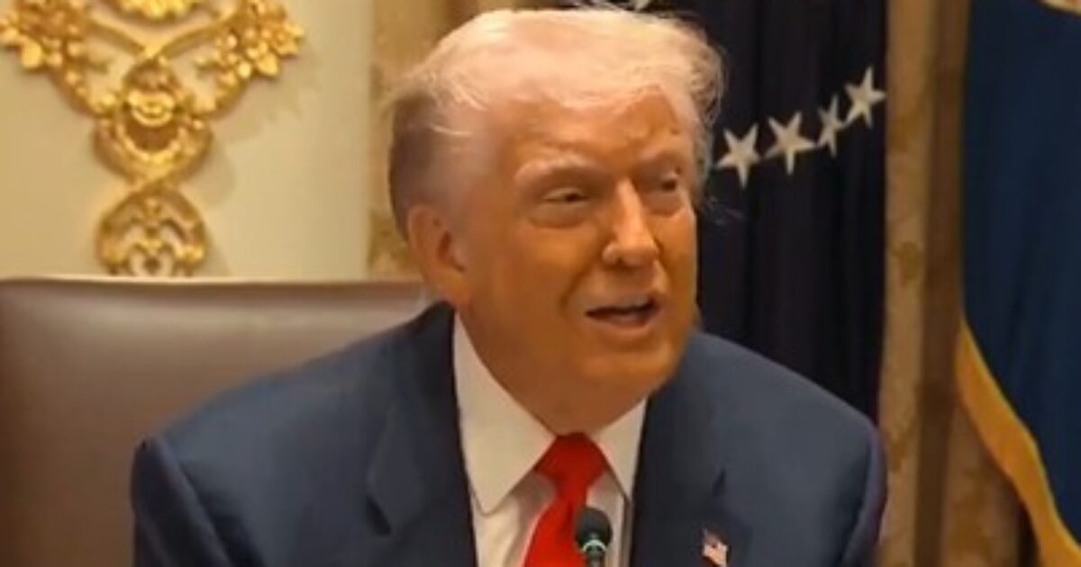 Former President Donald Trump speaking during a meeting in the Oval Office, showcasing his distinctive hairstyle and business attire.