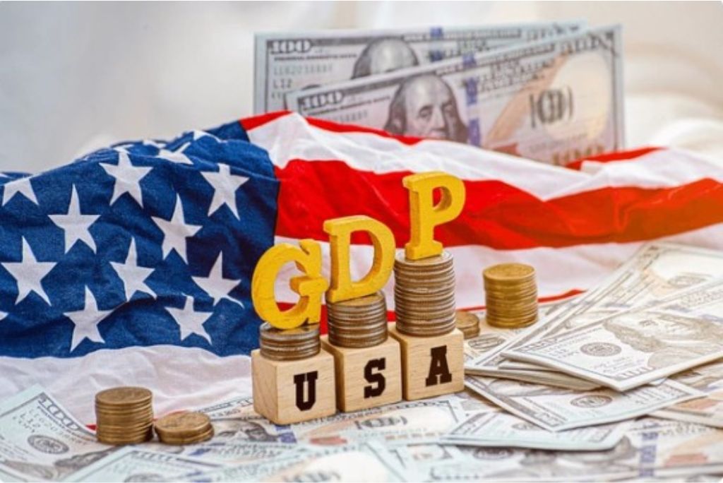 Image depicting the American flag with stacked coins and wooden blocks spelling GDP USA, symbolizing the economic growth and financial metrics of the United States.
