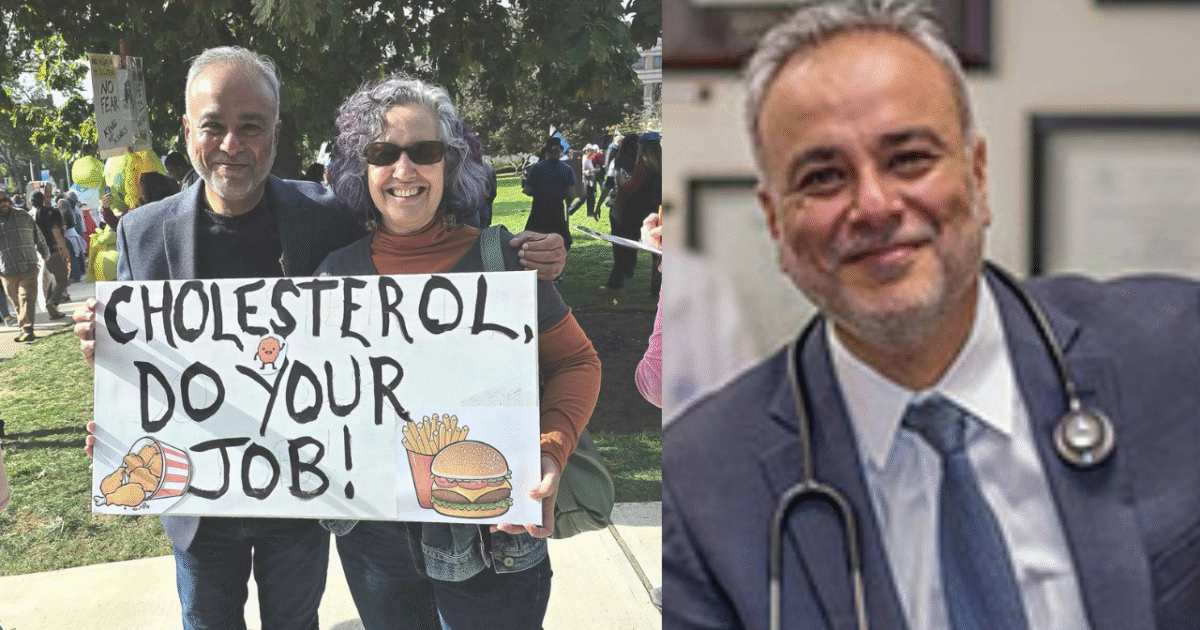 Two people hold a sign reading "Cholesterol, Do Your Job!" at a health awareness event, emphasizing the importance of managing cholesterol levels.
