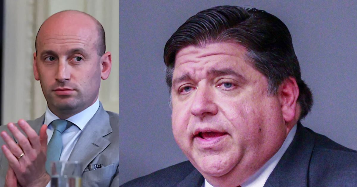 Two men engaged in discussion, one in a suit with a light blue tie and the other in a dark suit, both displaying focused expressions.