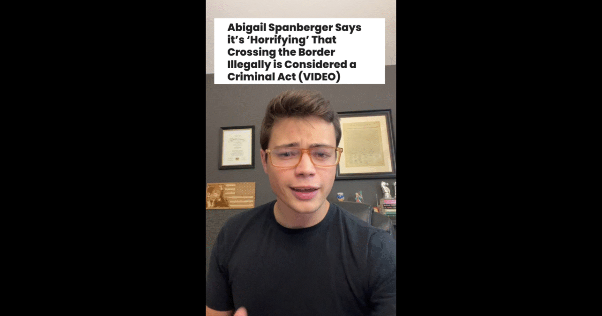 Young man discussing Abigail Spanberger's views on the implications of illegal border crossing in a home office setting, with framed documents and books in the background.
