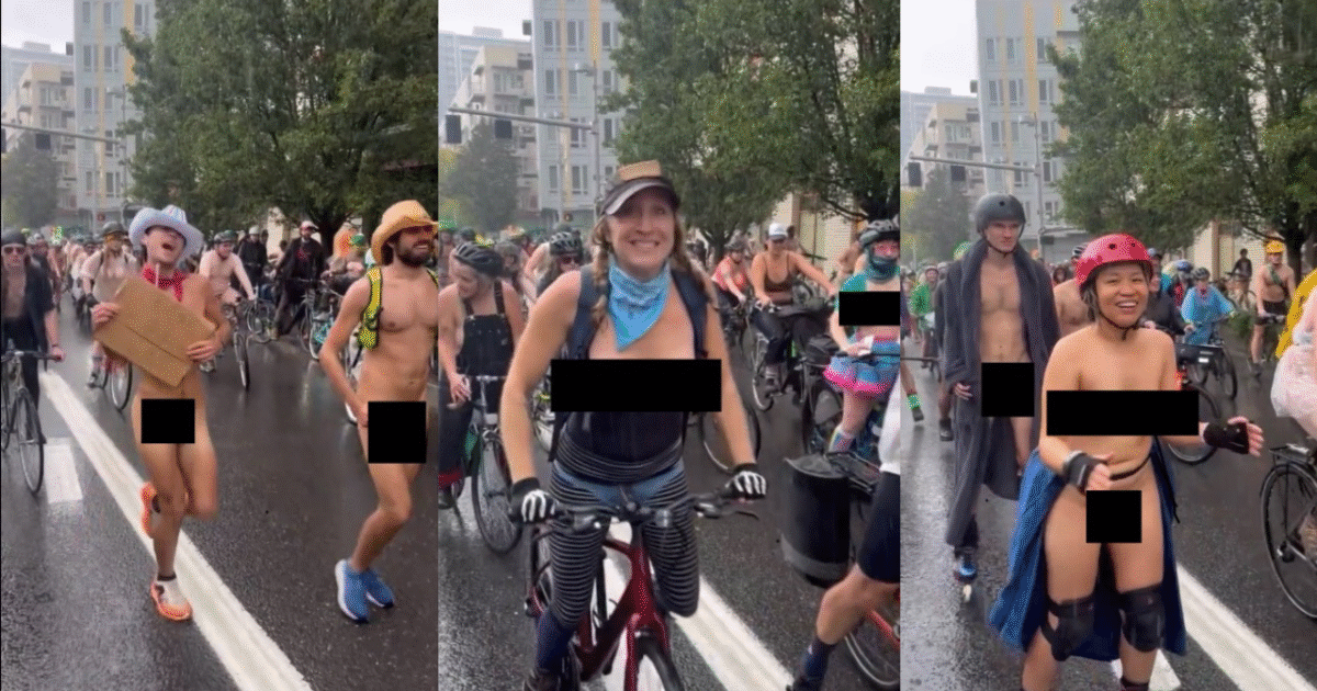 Participants in a colorful, partially nude bike parade ride through a rainy city street, celebrating body positivity and freedom of expression.