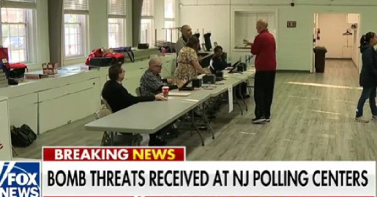 Image showing a New Jersey polling center with officials discussing bomb threats, highlighting a tense election day atmosphere.