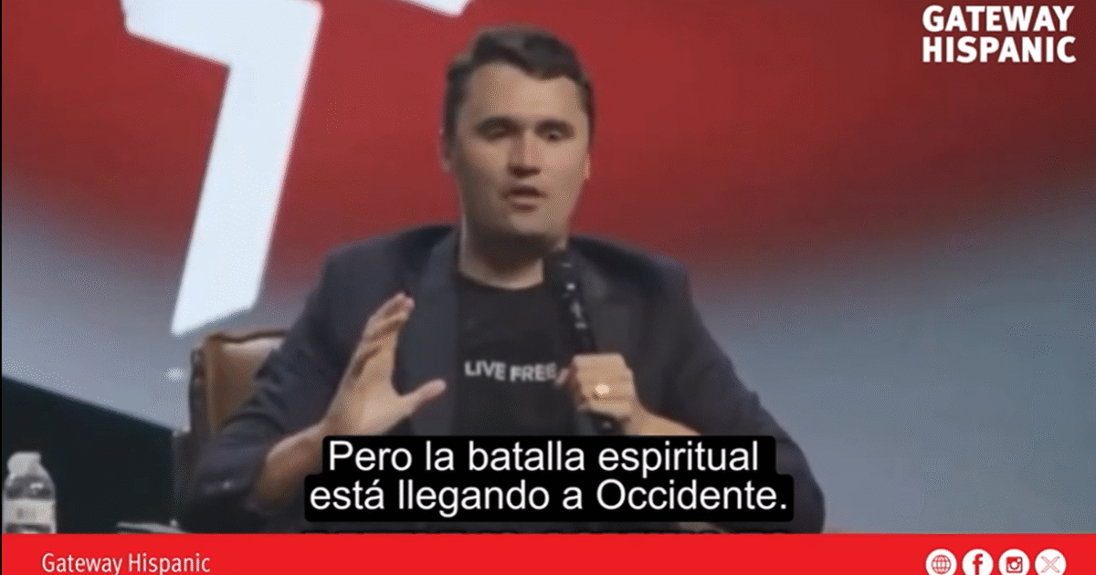 Speaker discussing spiritual battles in a conference setting, emphasizing the importance of awareness in the Western world.