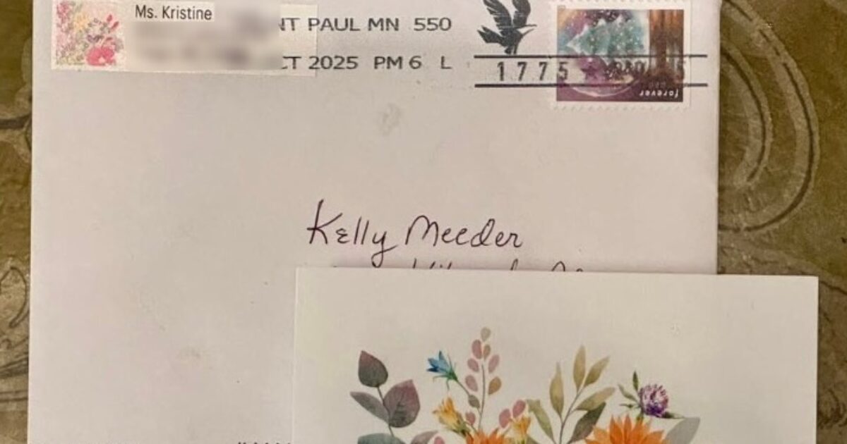 Envelope addressed to Kelly Meeder with floral card, featuring a postage stamp and handwritten details, showcasing personal correspondence.