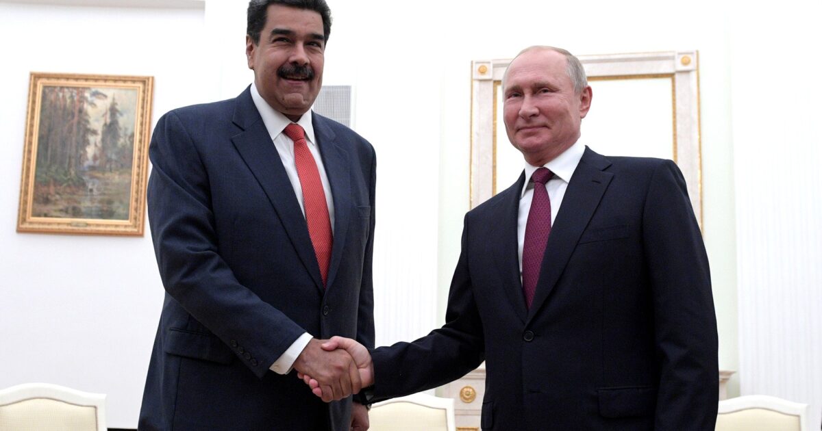 Venezuelan President Nicolás Maduro and Russian President Vladimir Putin shake hands during a diplomatic meeting in a formal setting.