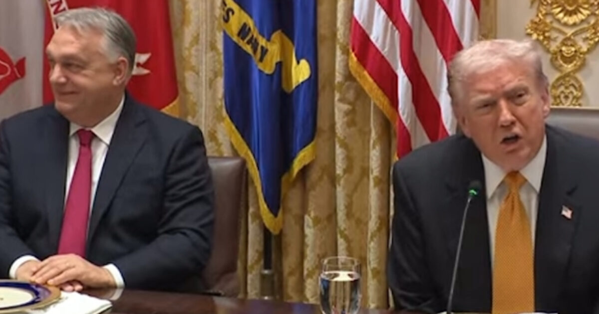 Former US President Donald Trump speaks during a meeting with Hungarian Prime Minister Viktor Orbán, surrounded by flags and official decor.