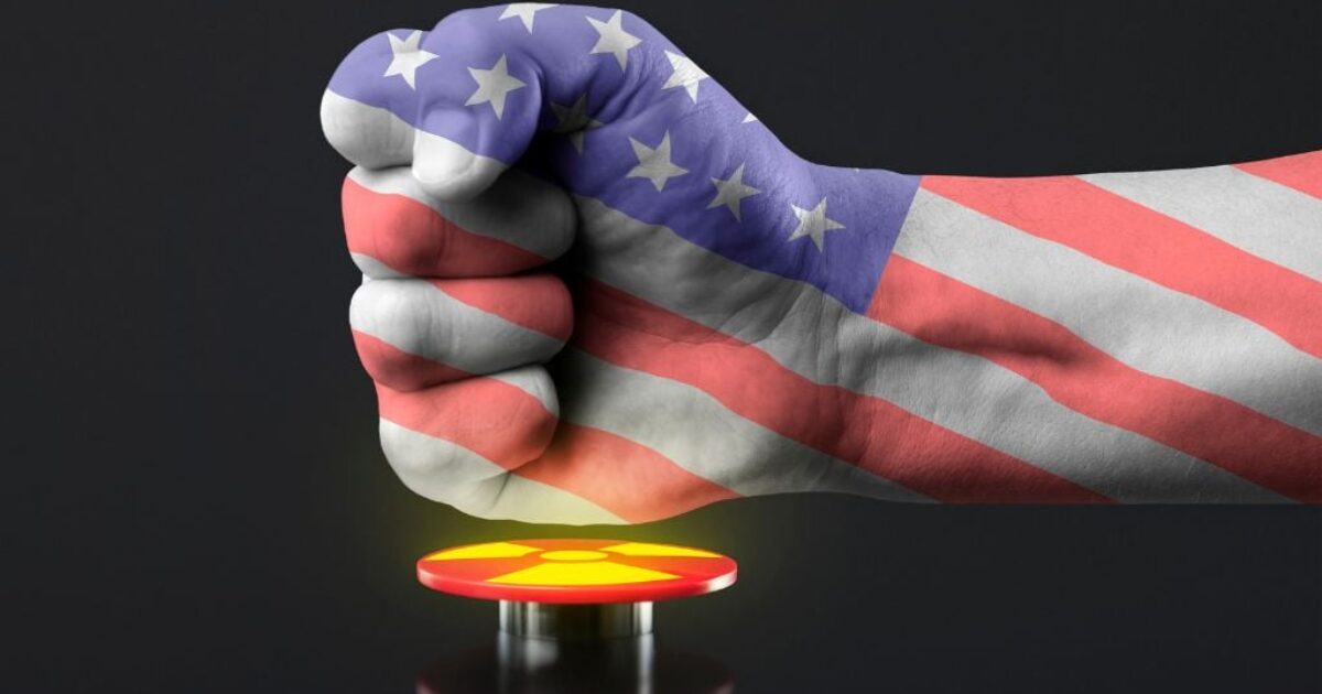 Fist covered in the American flag poised above a red button, symbolizing power and potential decision-making in a dramatic context.